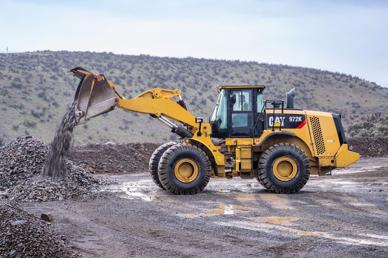 A wheel loader tipping rock onto a stockpile